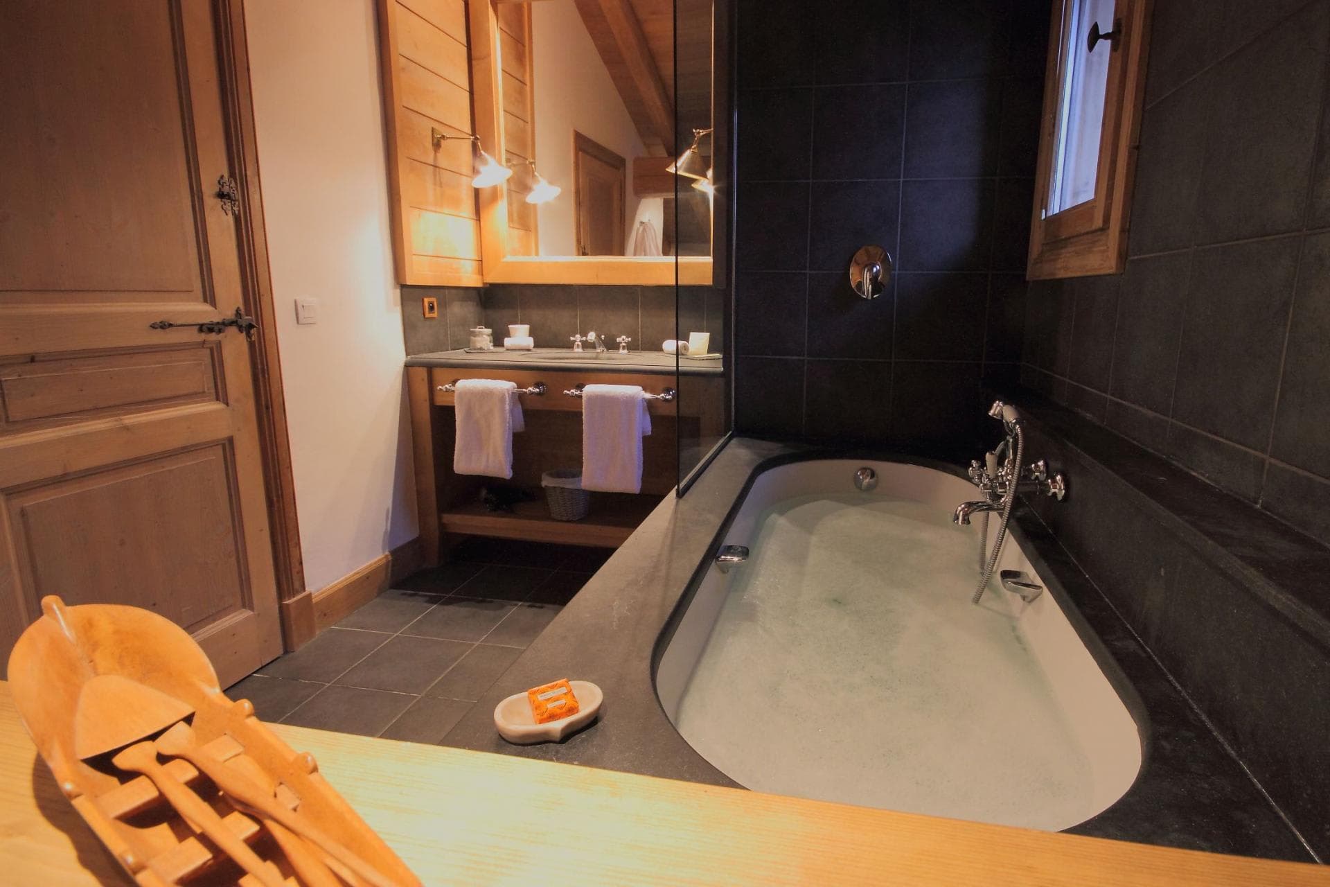 Bathroom with dual vanity and stone soaking tub