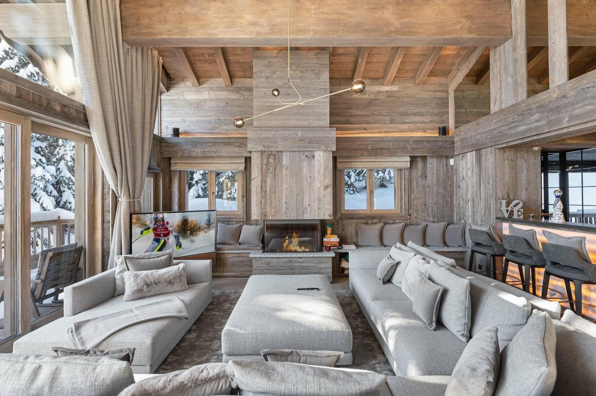 Living area with wood-burning fireplace and bar seating for four