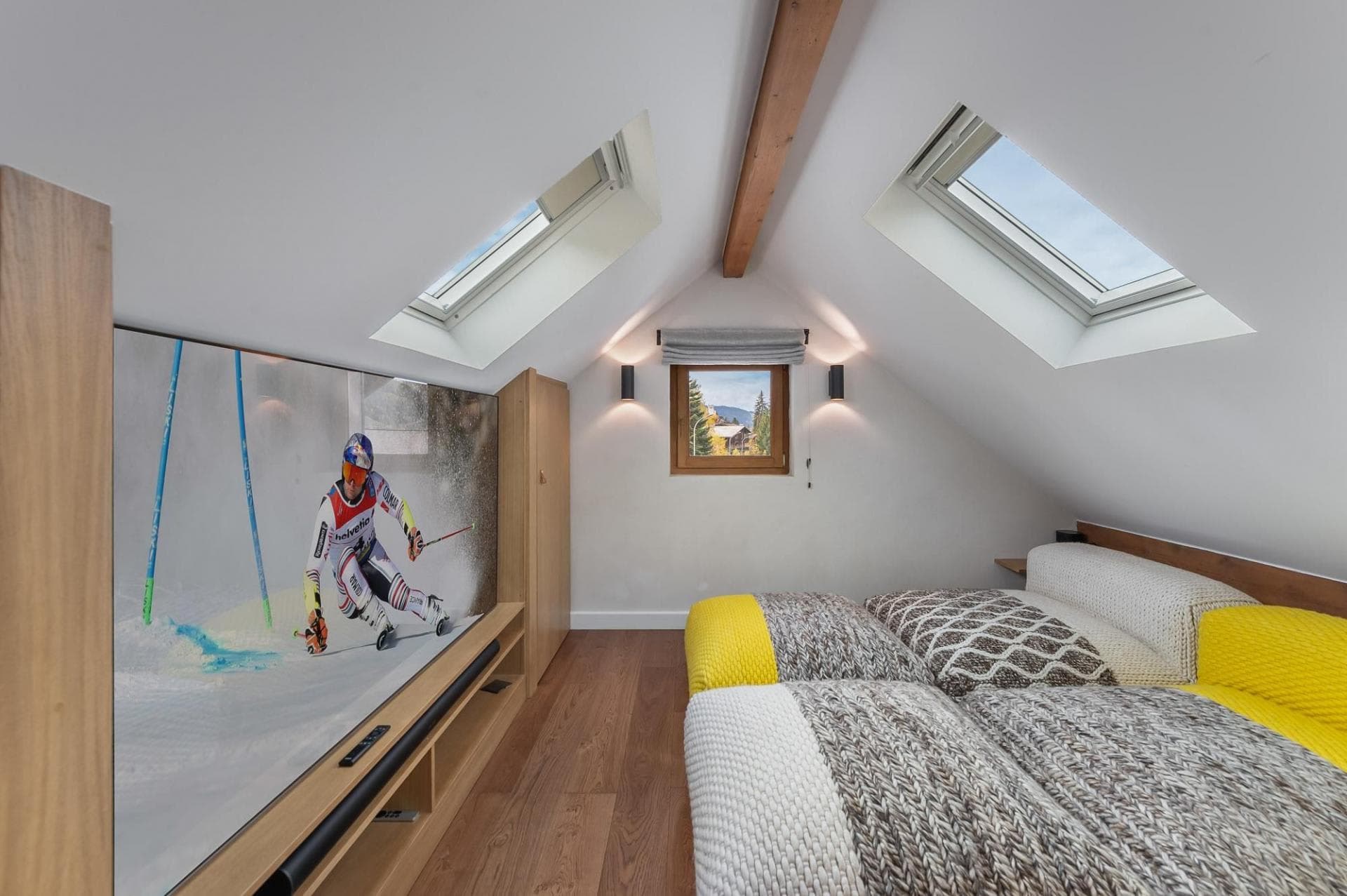 Attic media room with large-screen TV and dual skylights