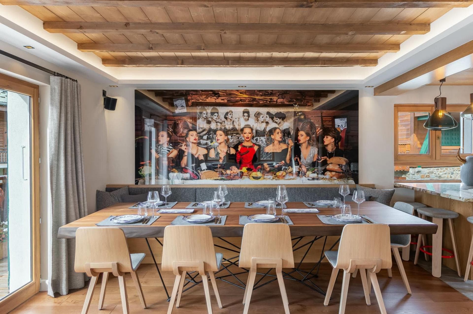 Dining area with banquet seating for 10 and wood-beamed ceilings