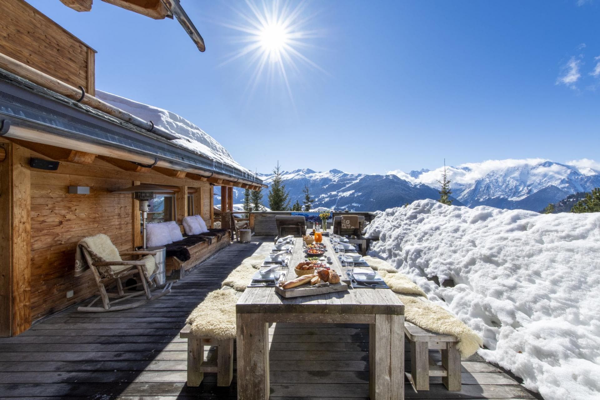 Chalet terrace with dining for 12, heat lamps, and mountain views