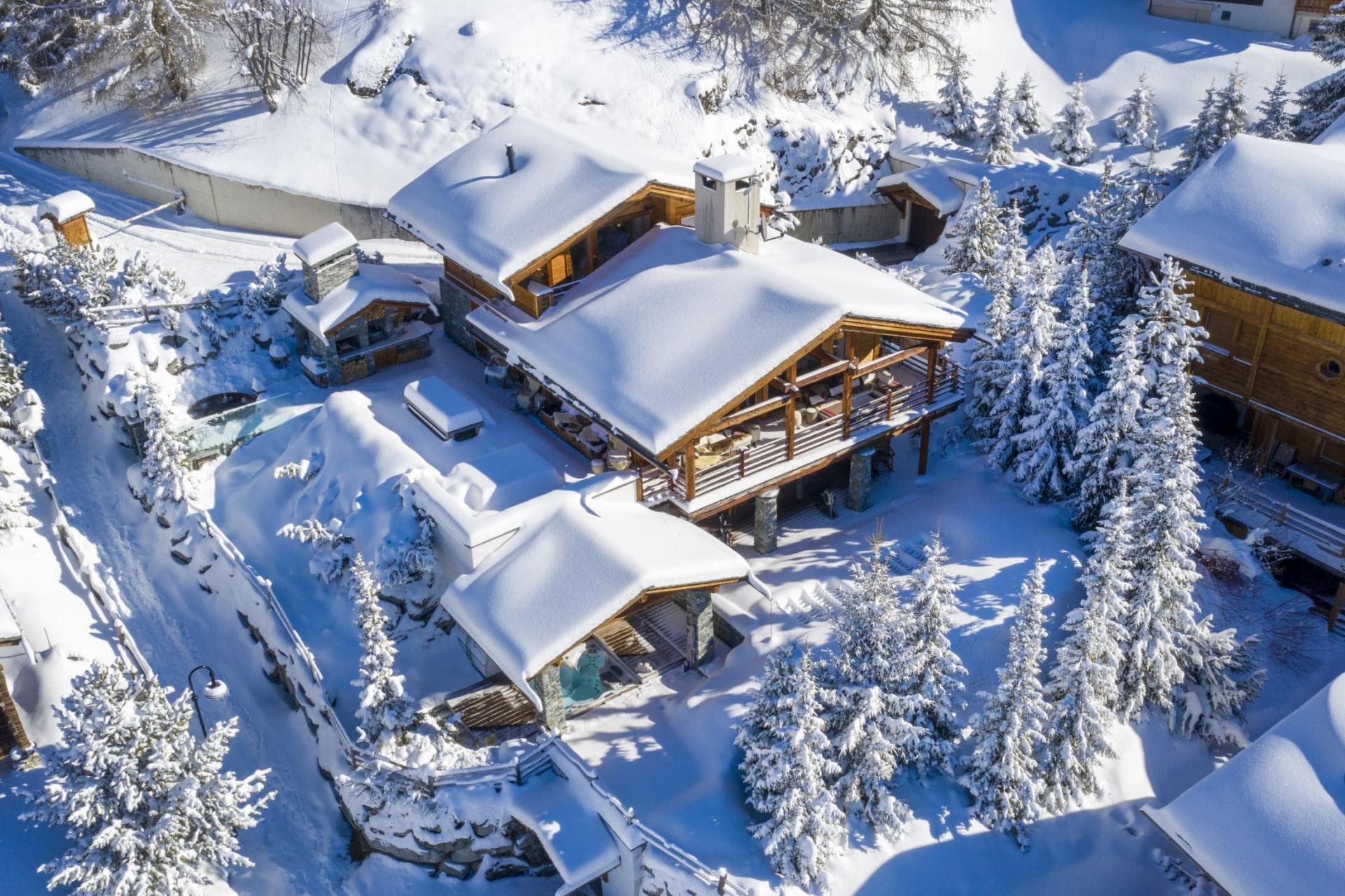 Aerial view of chalet featuring covered outdoor hot tub and stone pizza oven