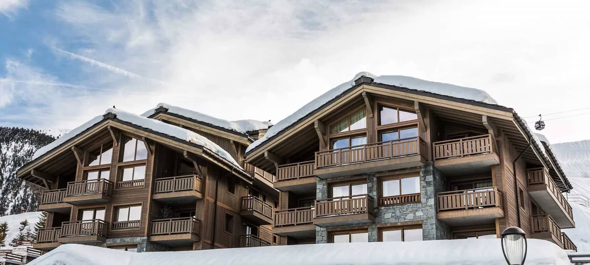 Ski-in/ski-out timber chalets with private balconies near gondola lift