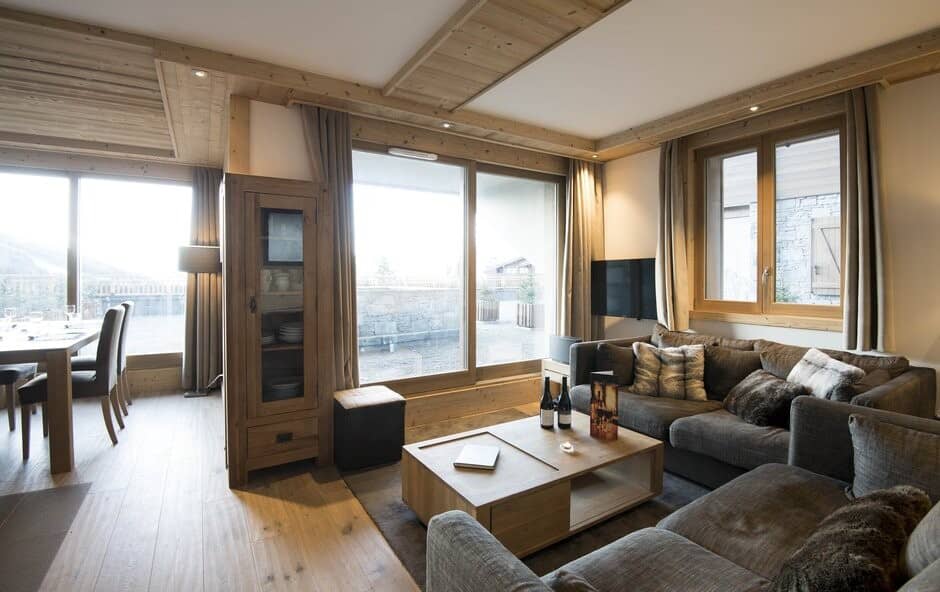 Open living area with sectional seating and access to private terrace