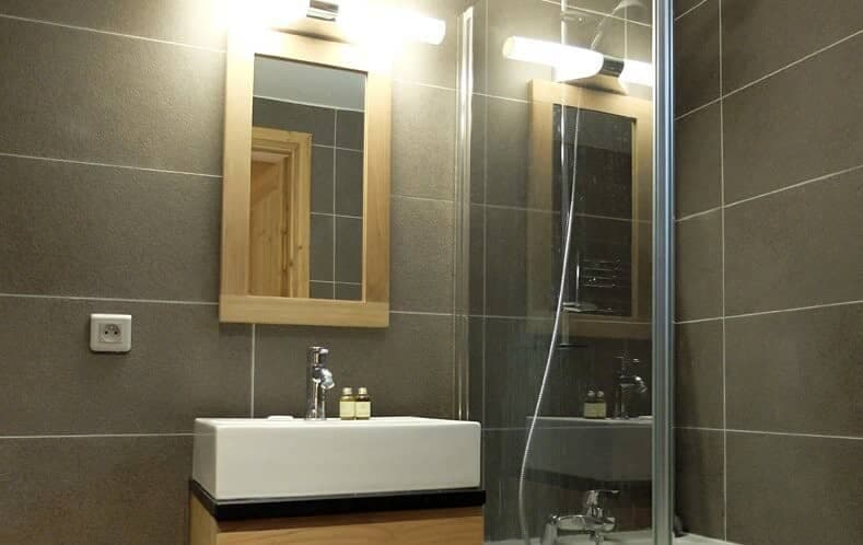 Bathroom with vessel sink and glass-enclosed walk-in shower