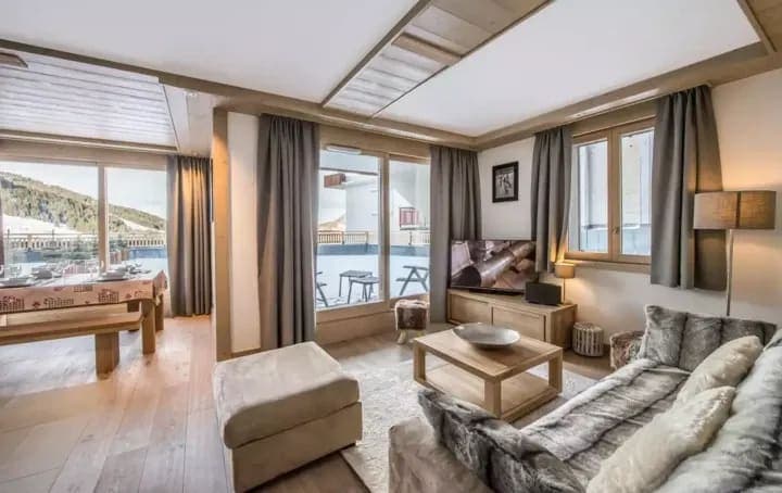 Open living area with smart TV and terrace access to ski slopes