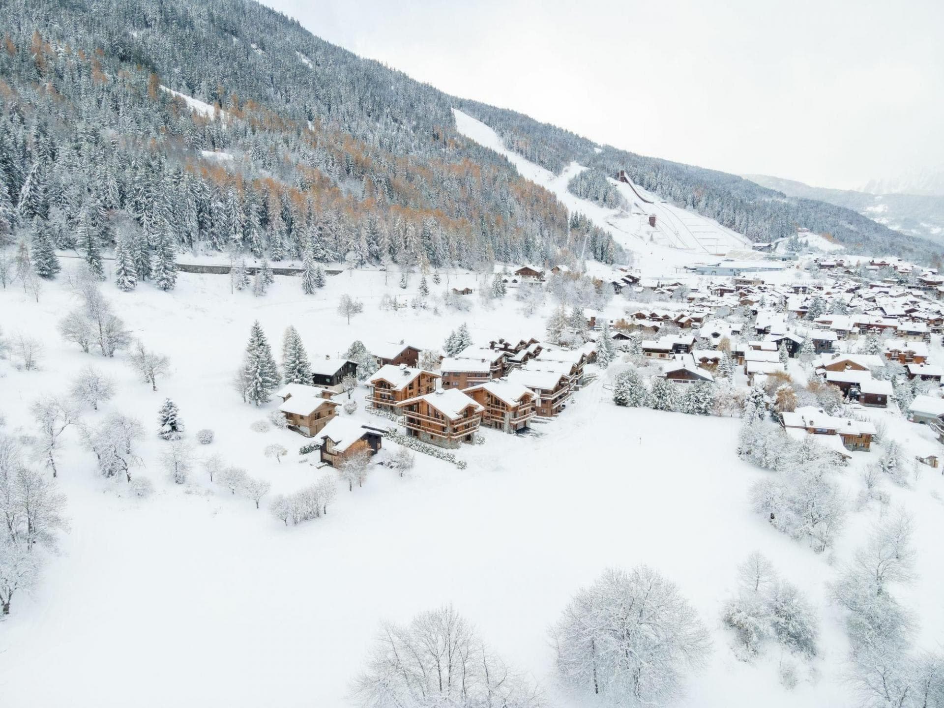 Aerial view of chalet village with immediate proximity to ski slopes