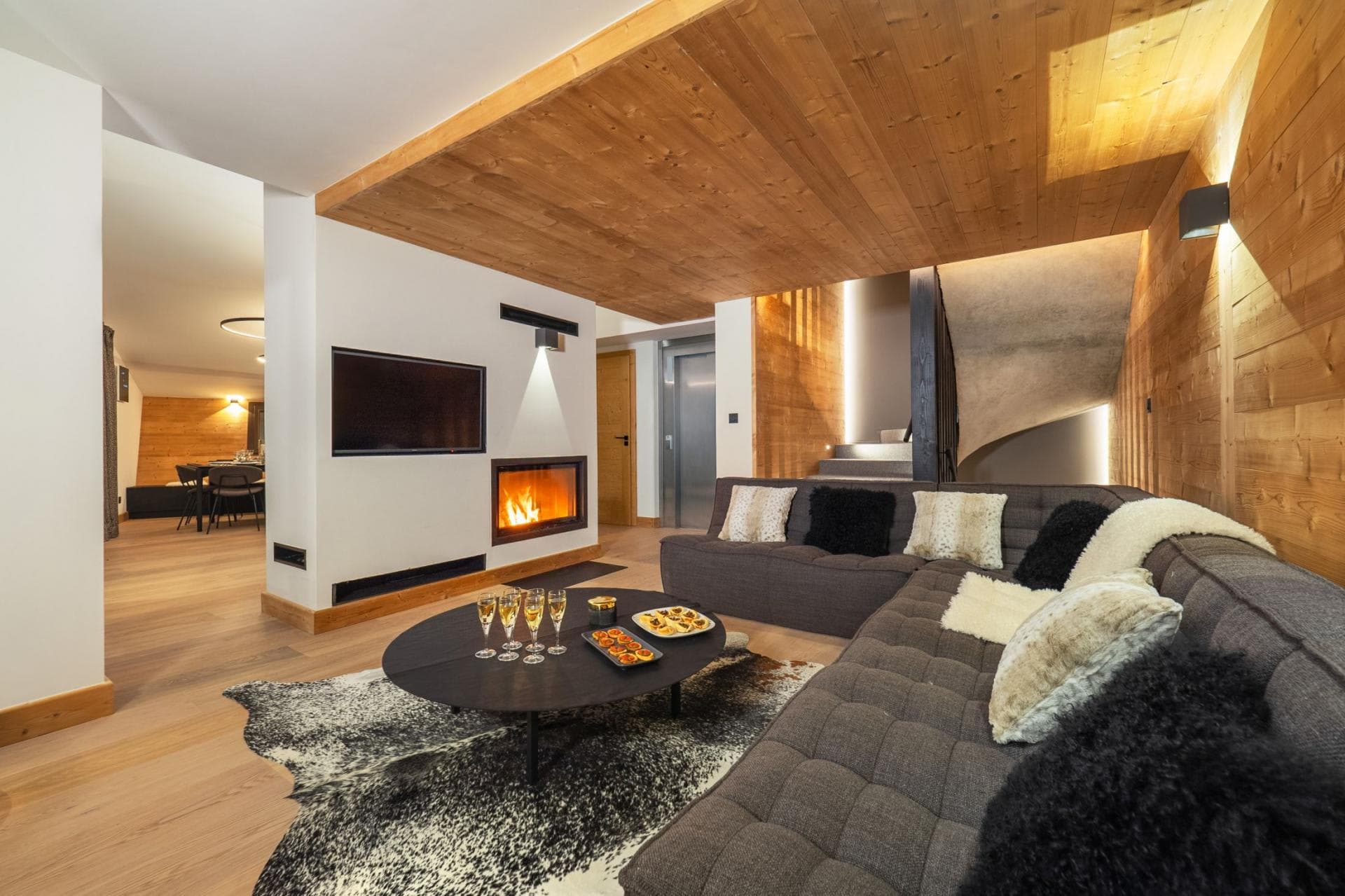 Living area with wood-burning fireplace and private elevator access