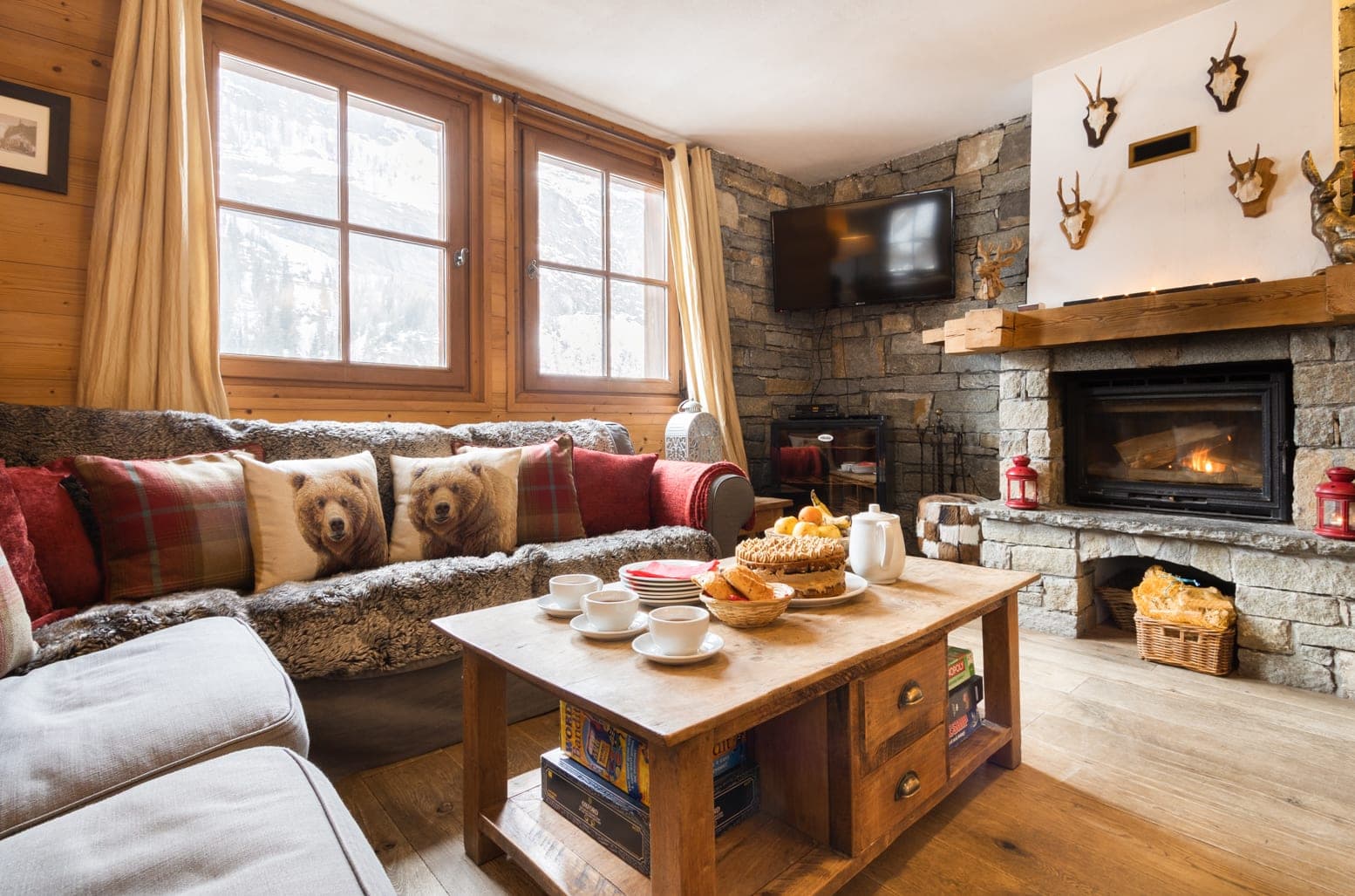 Living area with wood-burning fireplace and mountain-view windows