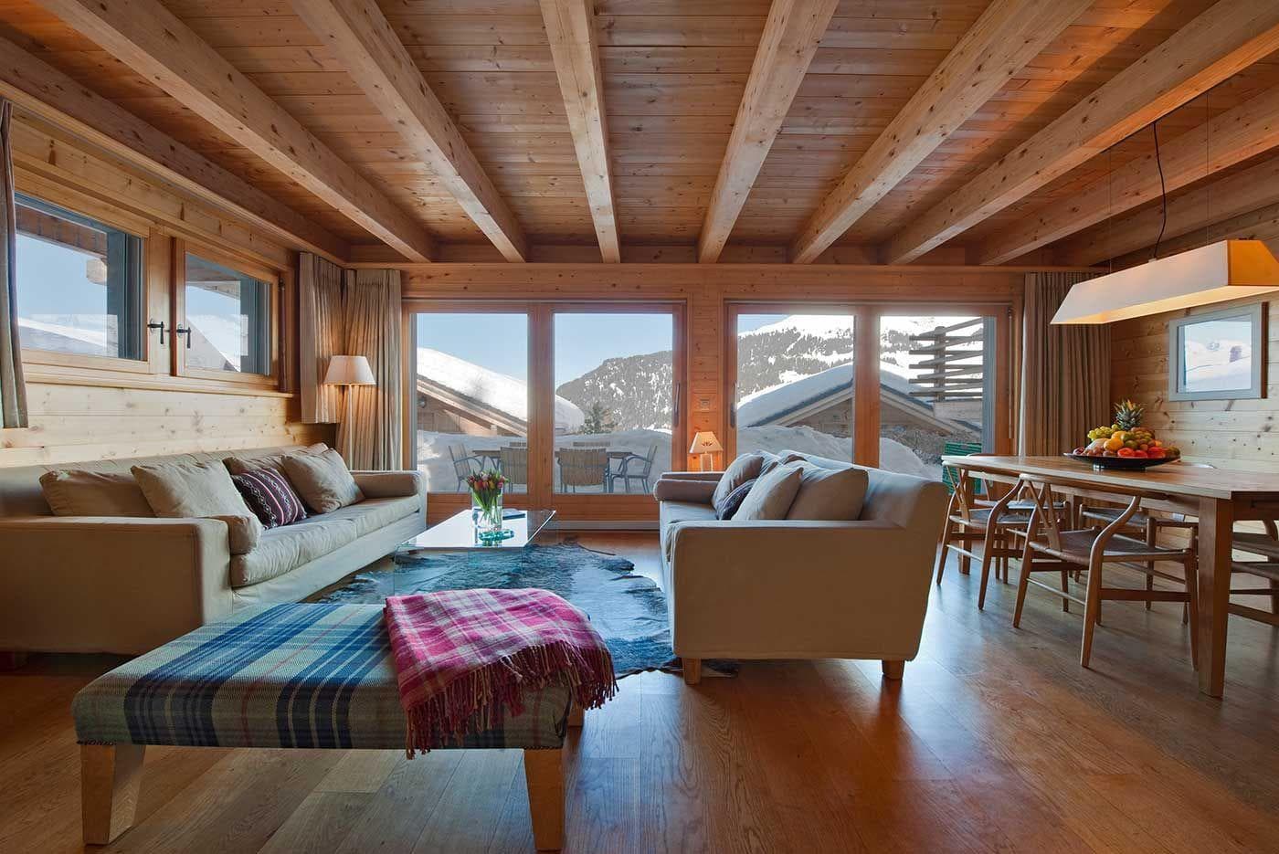 Open-plan living area with timber ceilings and mountain views