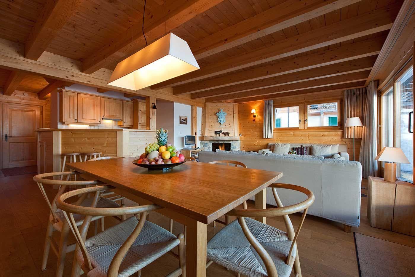 Open-plan dining area seating 6; wood-burning fireplace and exposed timber beams