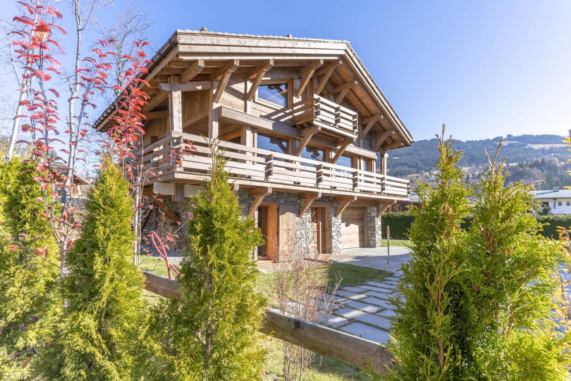 Timber chalet exterior with stone foundation and integrated garage