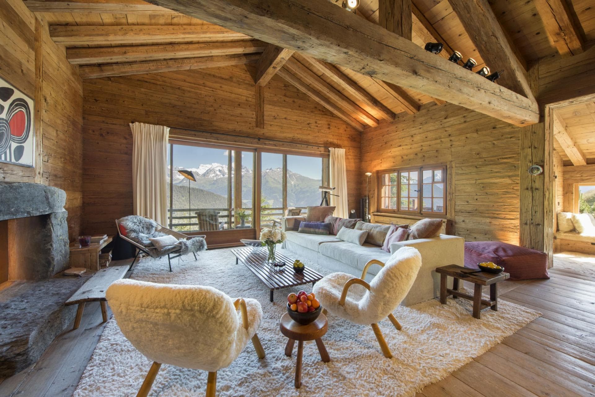 Living area with wood-burning fireplace and panoramic alpine views