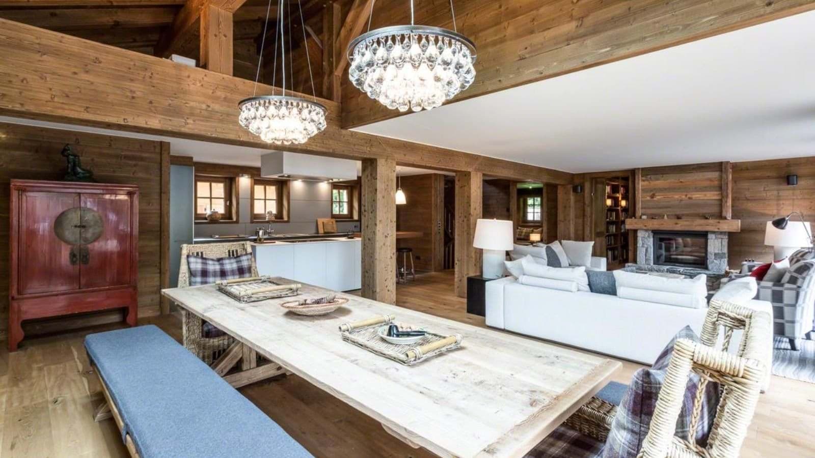 Open-plan living area with timber-beamed ceilings and wood-burning fireplace