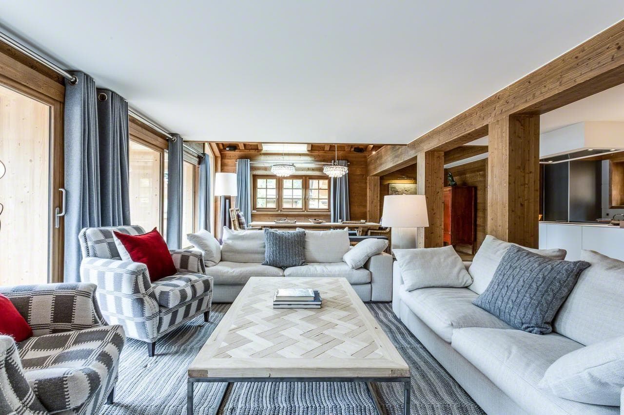 Open-plan living area with balcony access and views into the dining room
