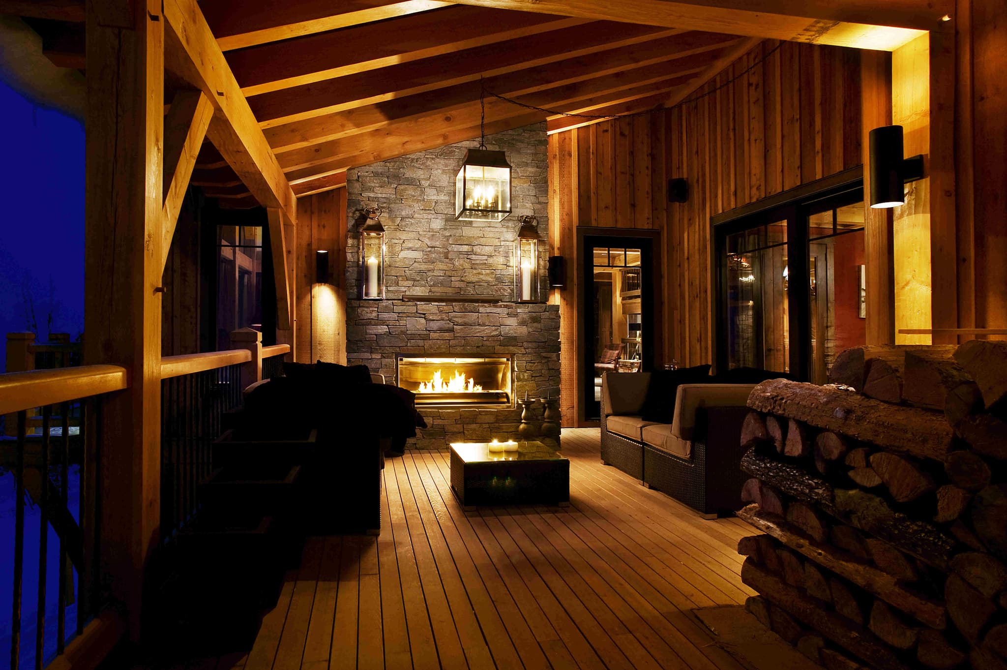 Covered deck with stone gas fireplace and lounge seating