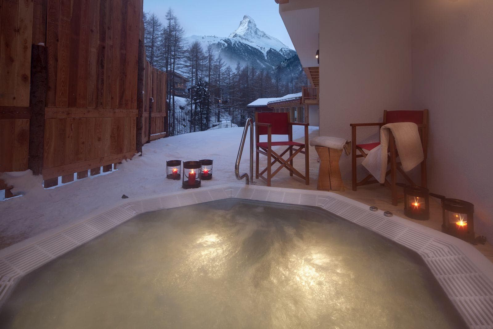 Outdoor hot tub with seating and direct Matterhorn views