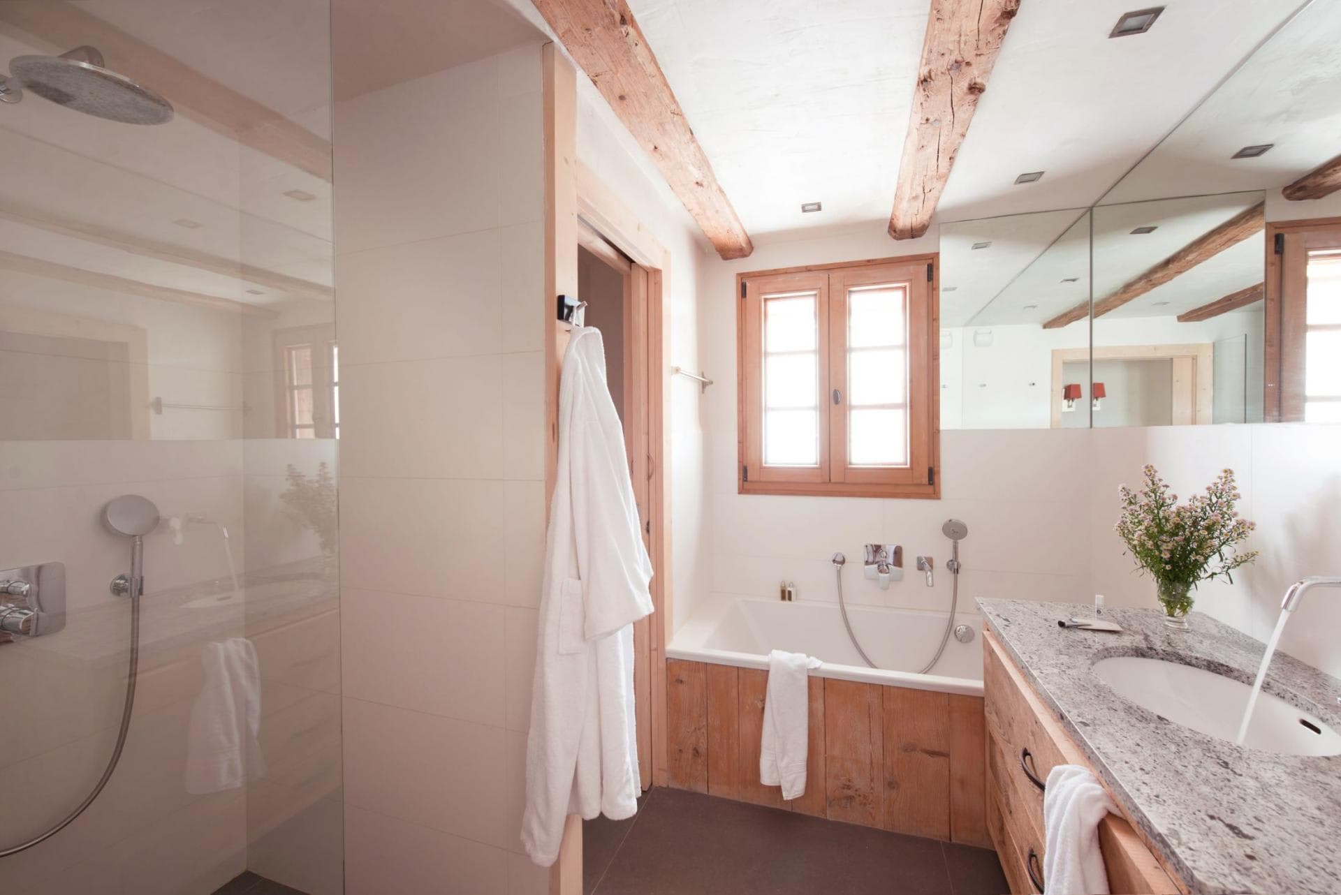 Bathroom with walk-in rainfall shower and separate soaking tub