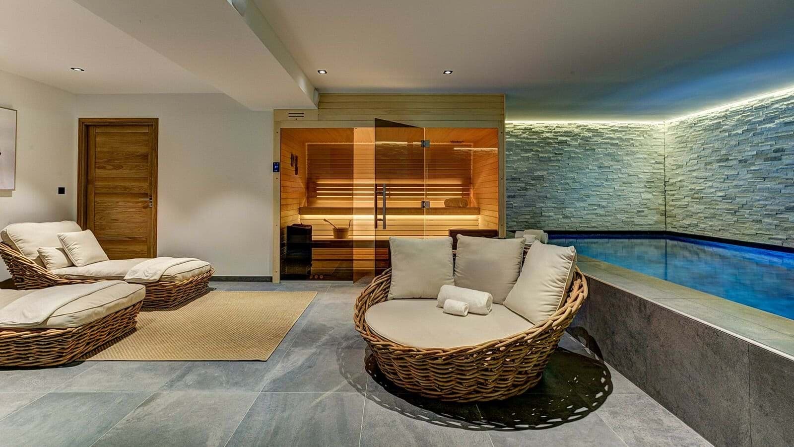 Indoor wellness area with cedar sauna, heated plunge pool, and lounge seating