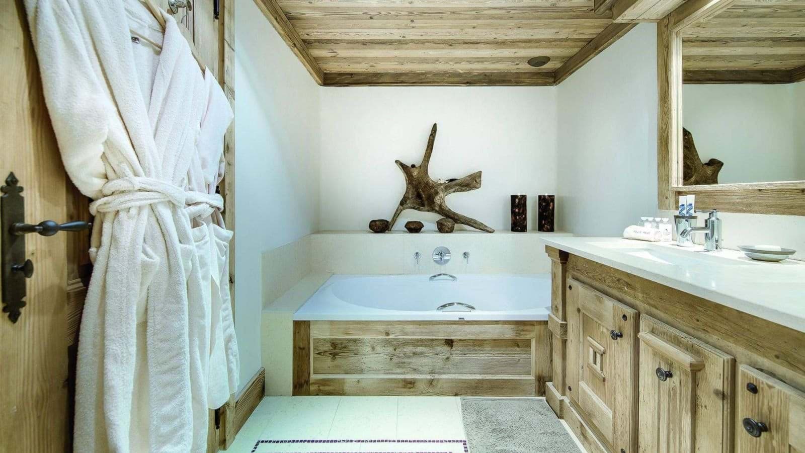 Bathroom with soaking tub, double vanity, and rustic wood accents throughout
