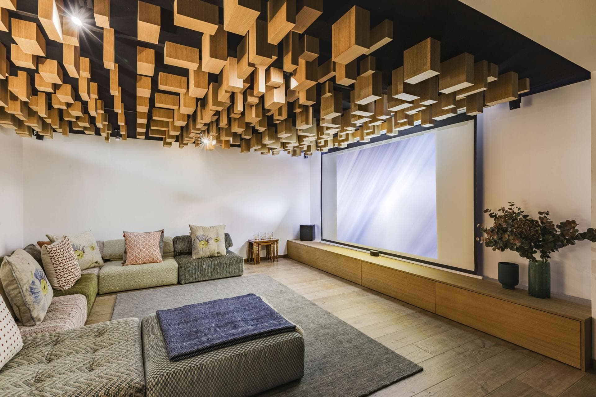 Home theater with projection screen; acoustic wood ceiling absorbs sound