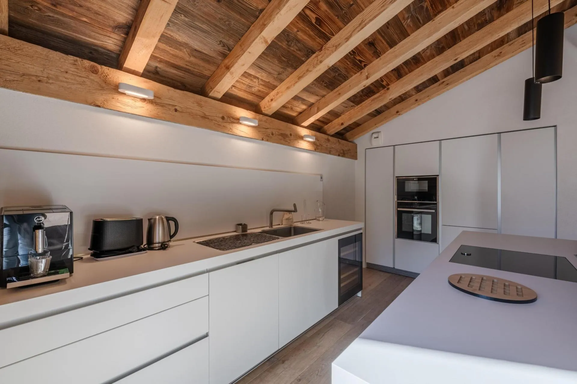 Fitted kitchen with white cabinetry and integrated appliances