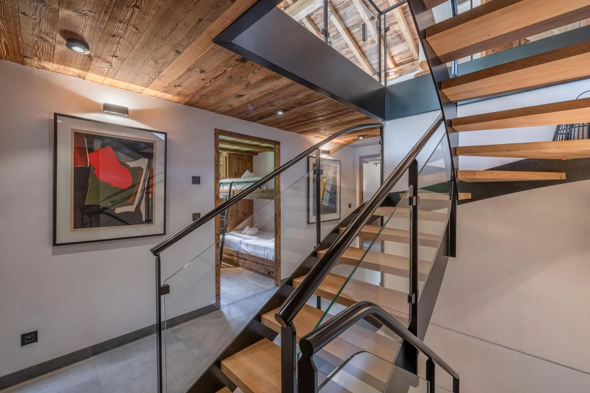 Open staircase with glass balustrade beside the sleeping area