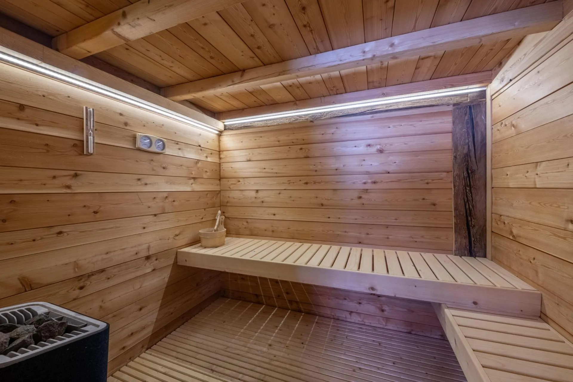 Timber-lined private sauna with tiered bench seating
