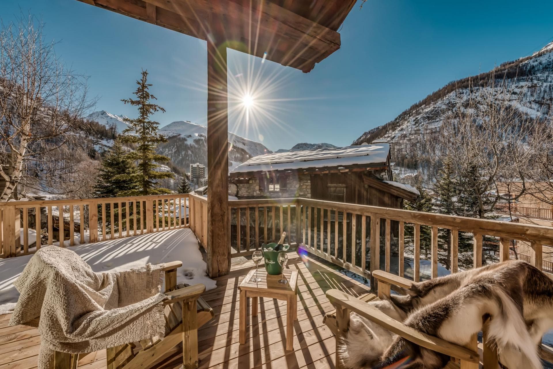 Private sun deck with wood seating and south-facing mountain views