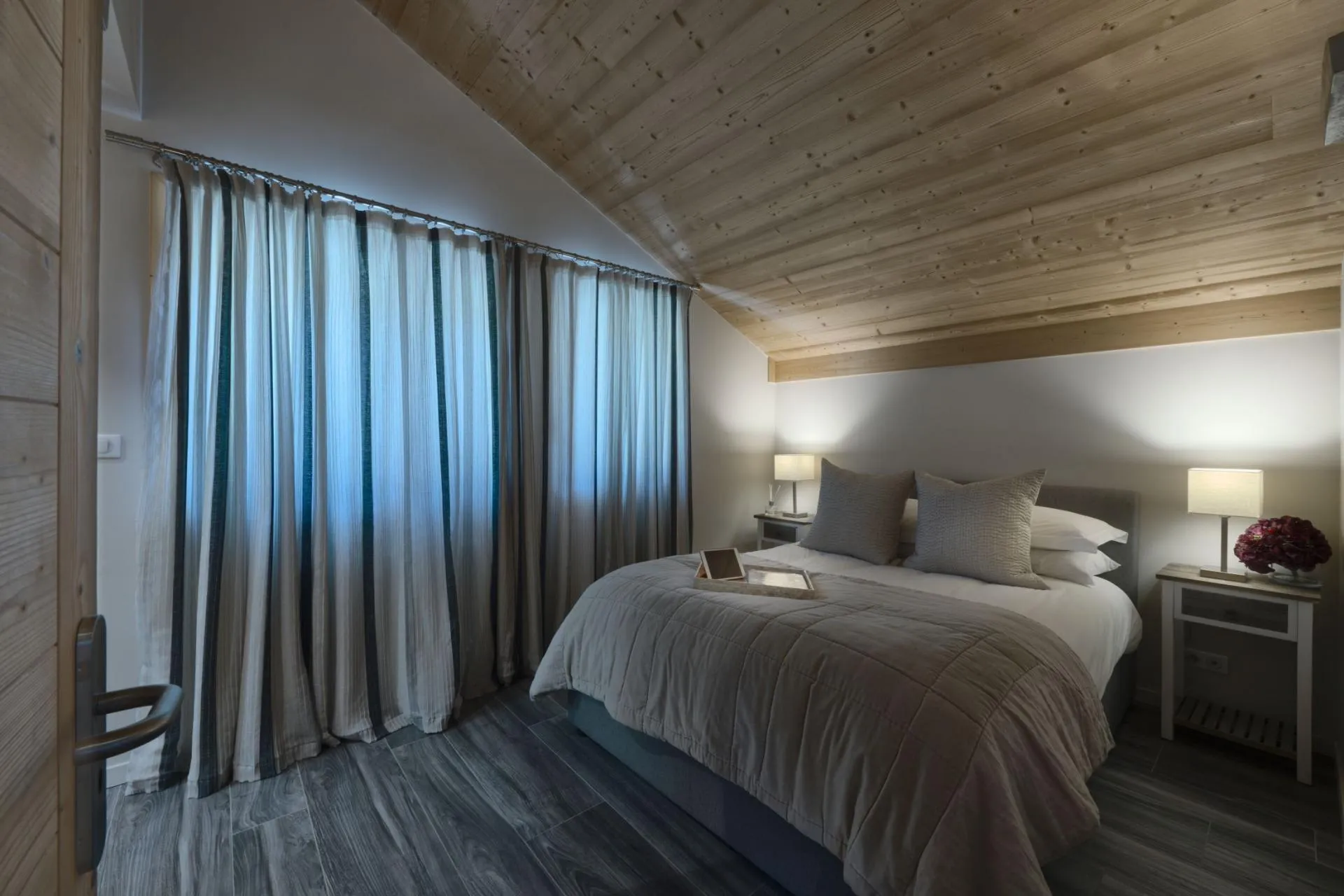 Bedroom with queen bed and vaulted wood ceiling