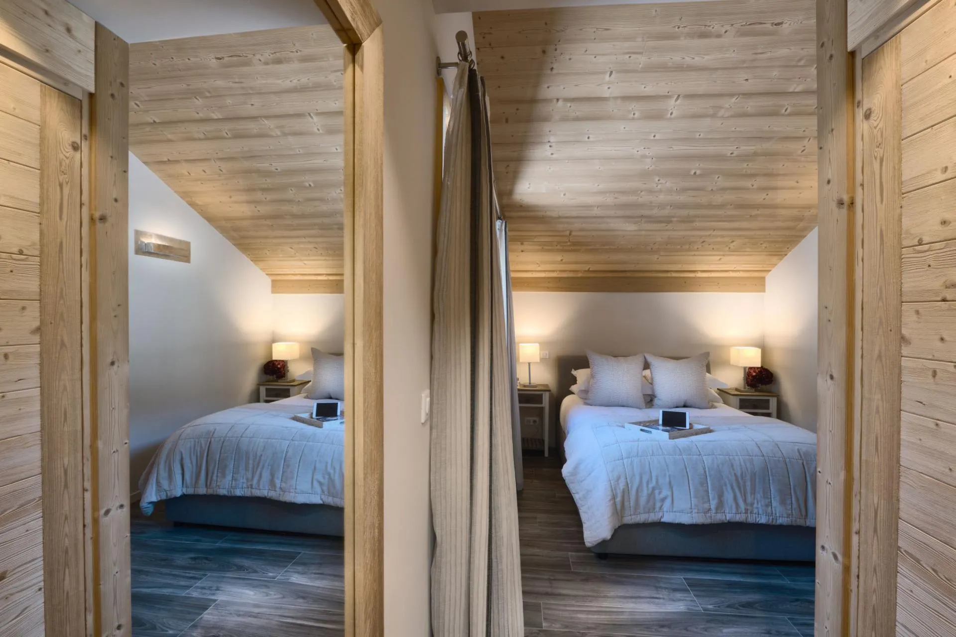 Bedroom with queen bed and slanted timber ceiling