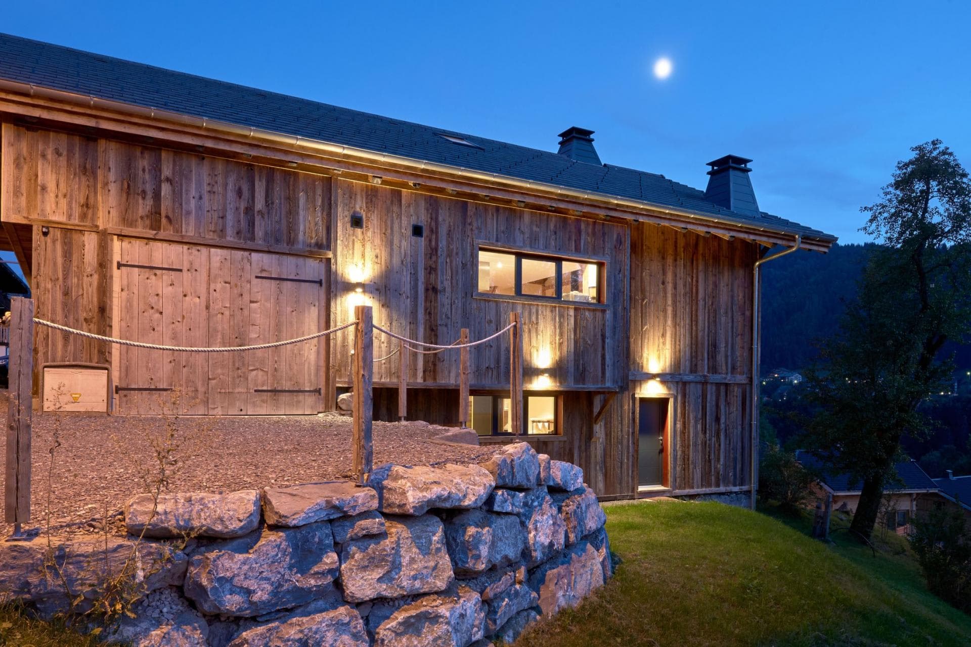 Chalet exterior with timber cladding and gravel parking area