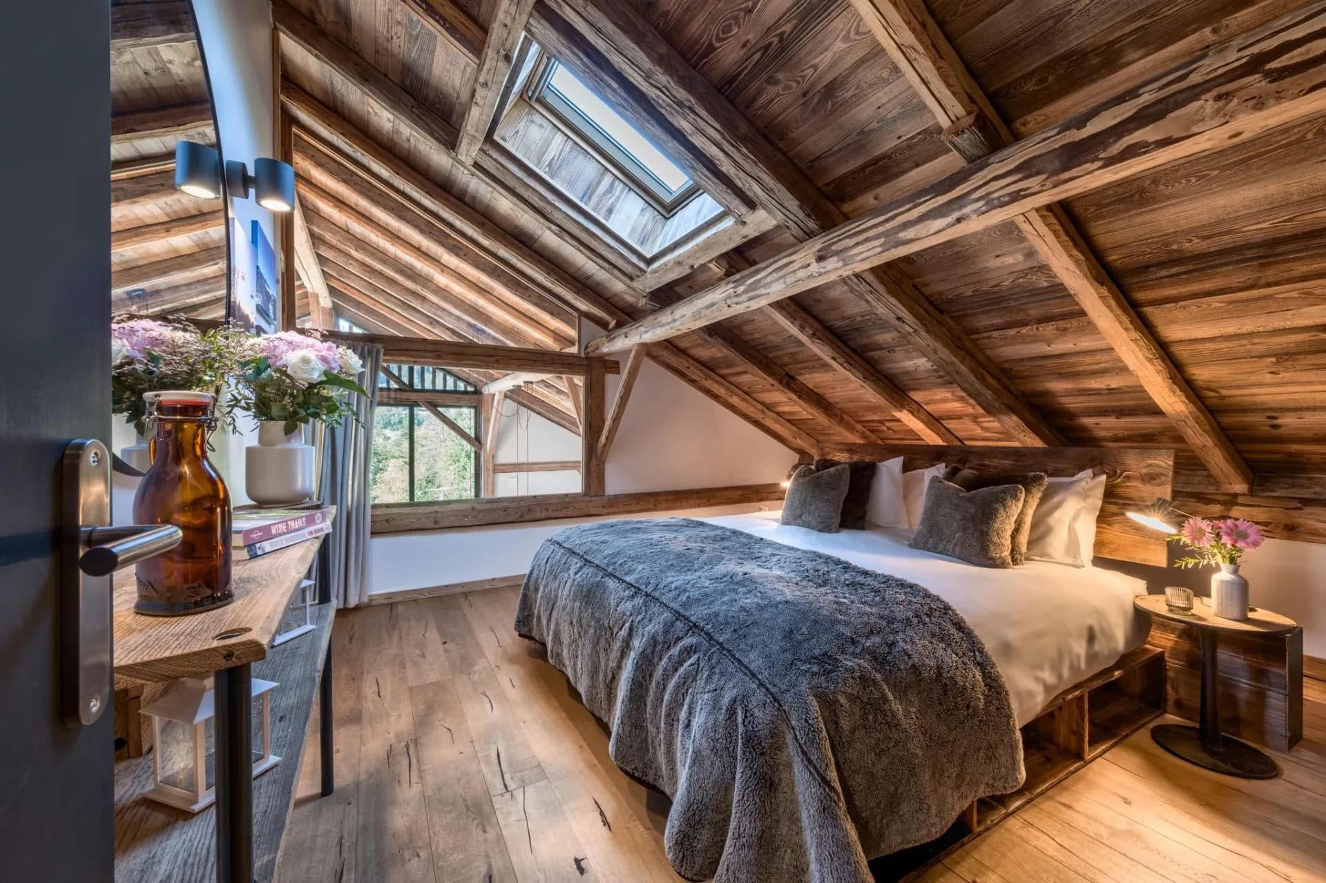Master bedroom with king-sized bed, exposed timber beams and skylight