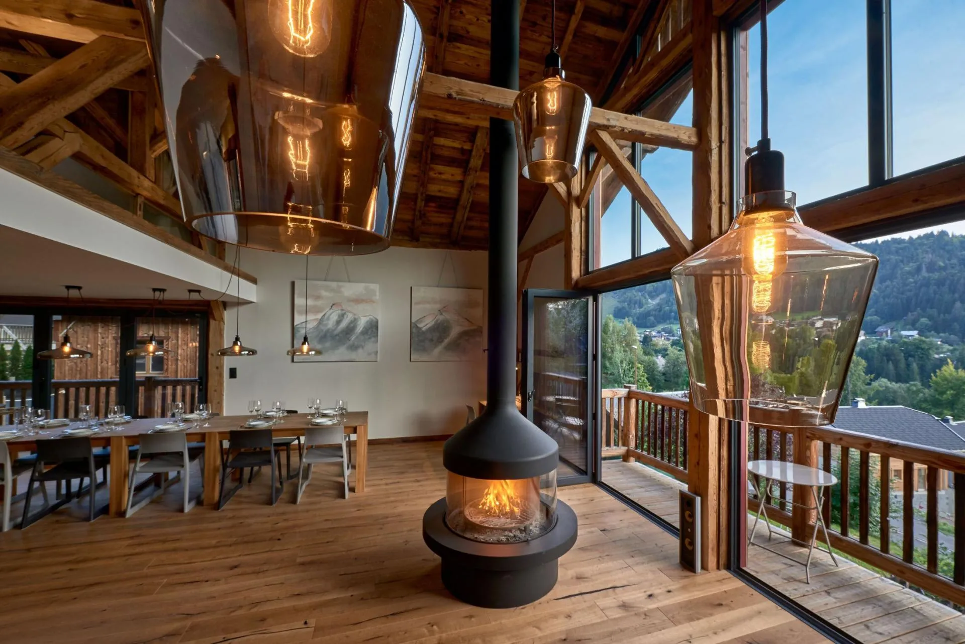 Open-plan dining area with wood-burning fireplace and balcony access