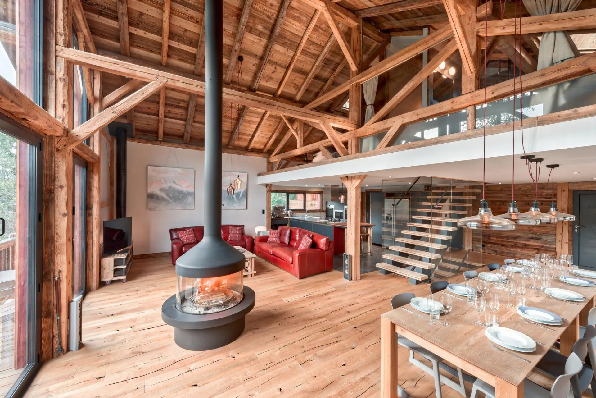 Open-plan living and dining area with central wood-burning fireplace