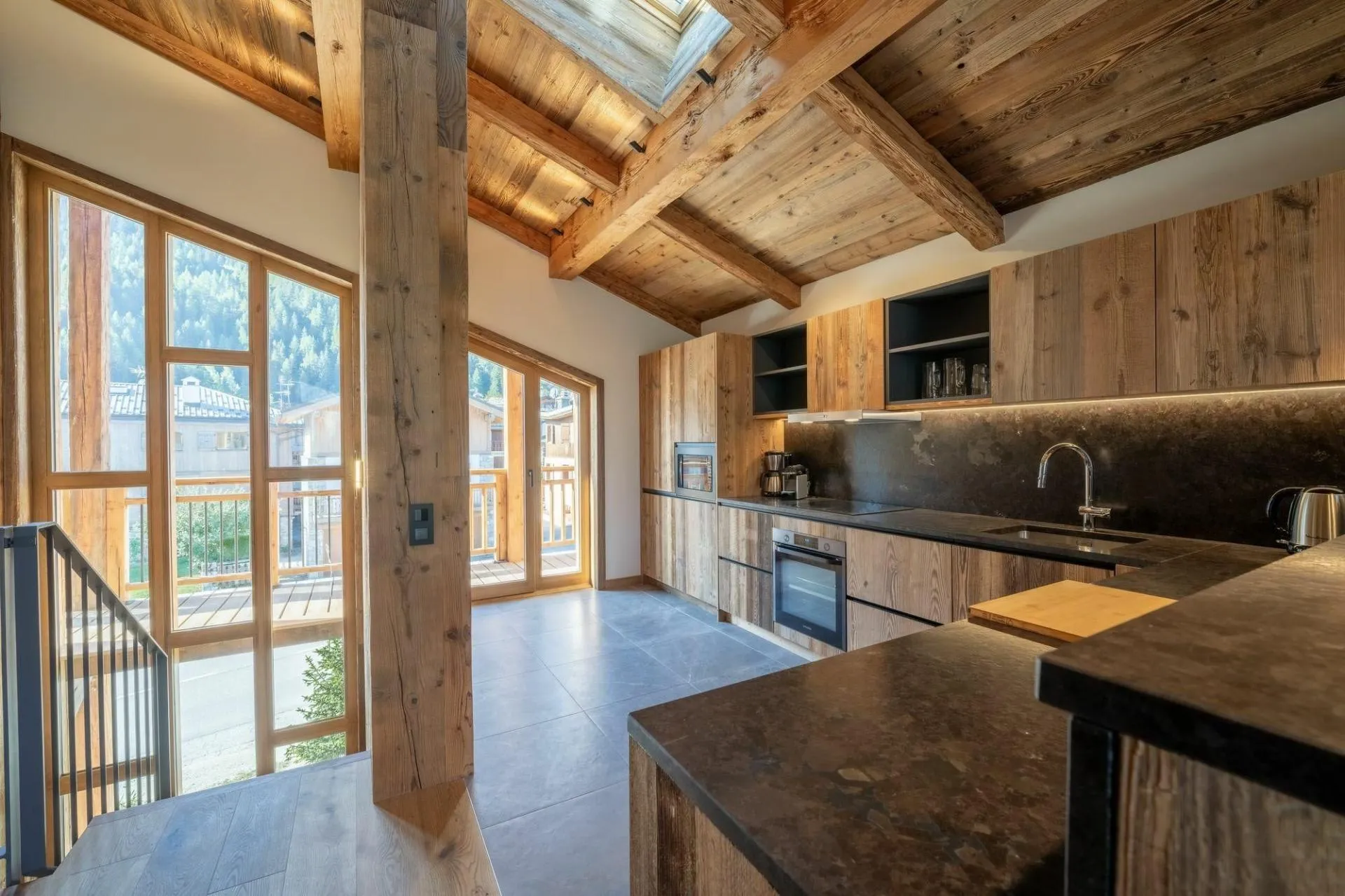 Semi-open fitted kitchen beside the balcony doors