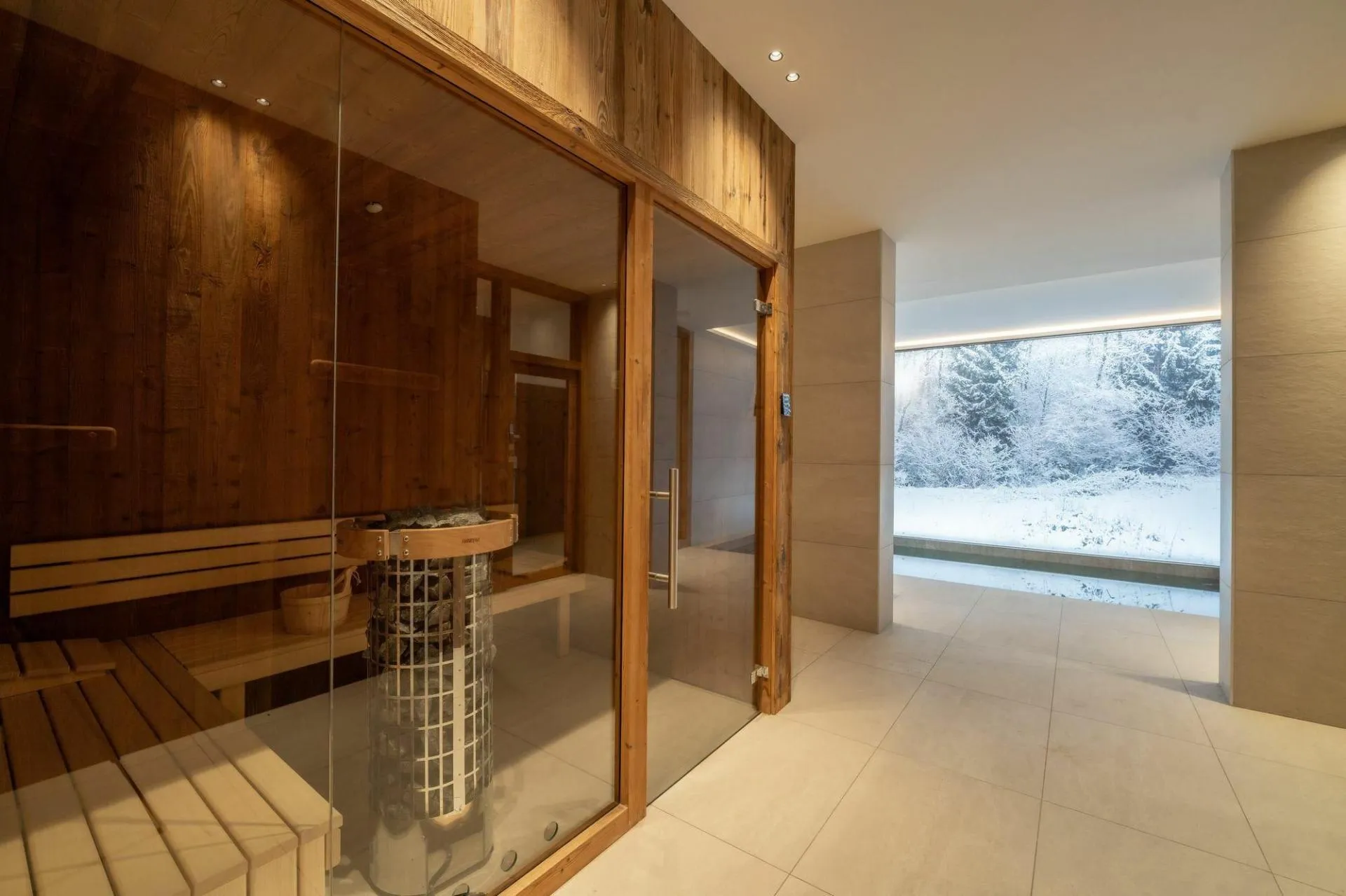 Glass-fronted sauna beside the indoor swimming pool