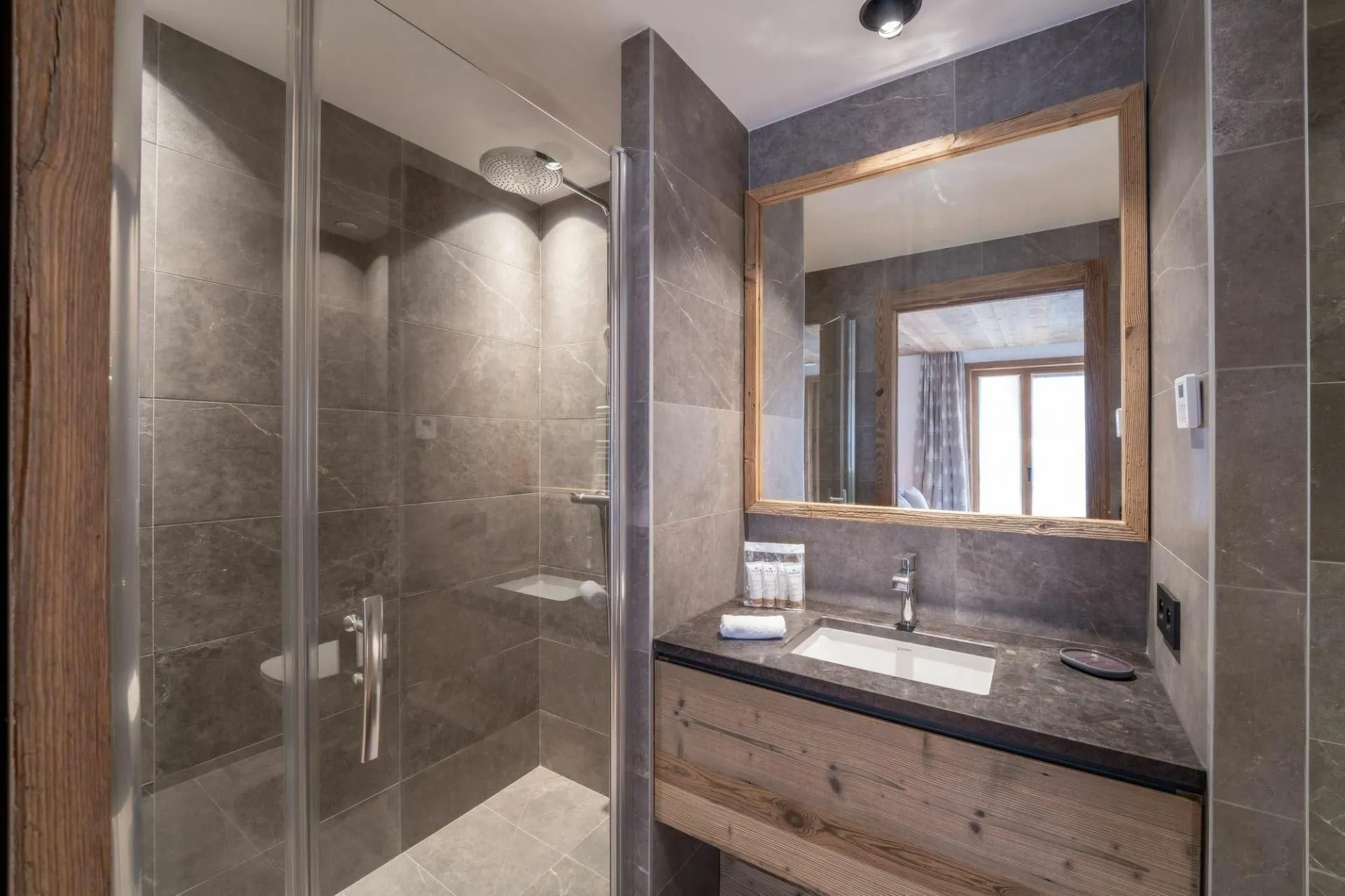 En-suite shower room with basin and heated towel rail