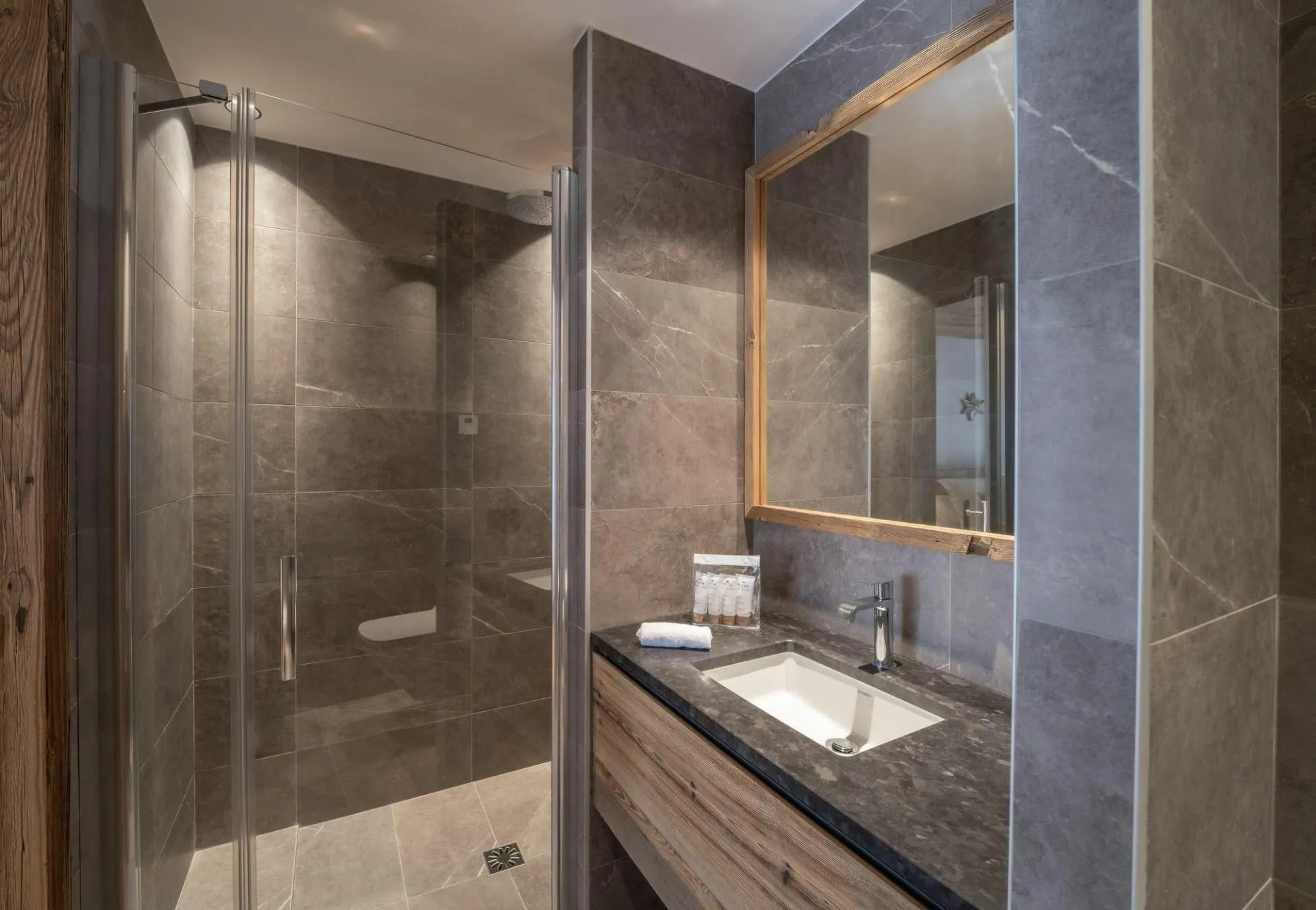 En-suite shower room with basin and heated towel rail