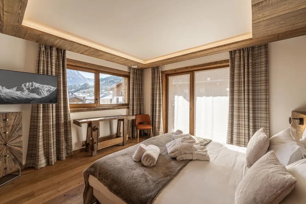 Bedroom seating area beside glazed doors