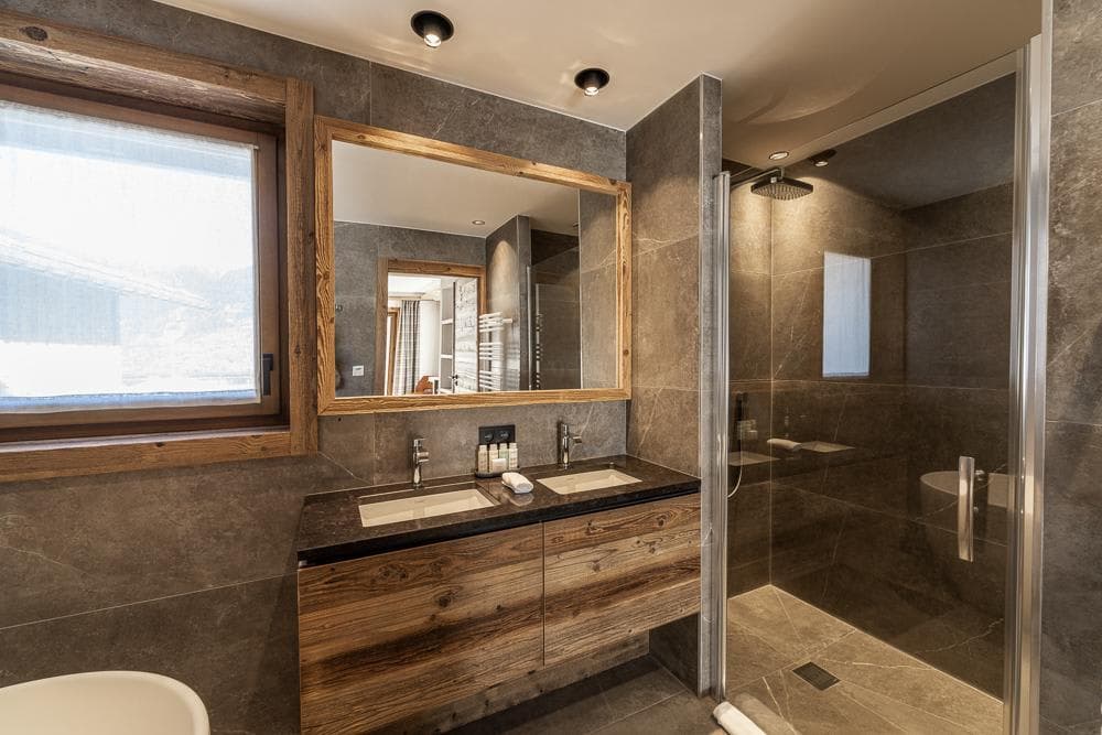 Bathroom with dual vanity and walk-in rain shower