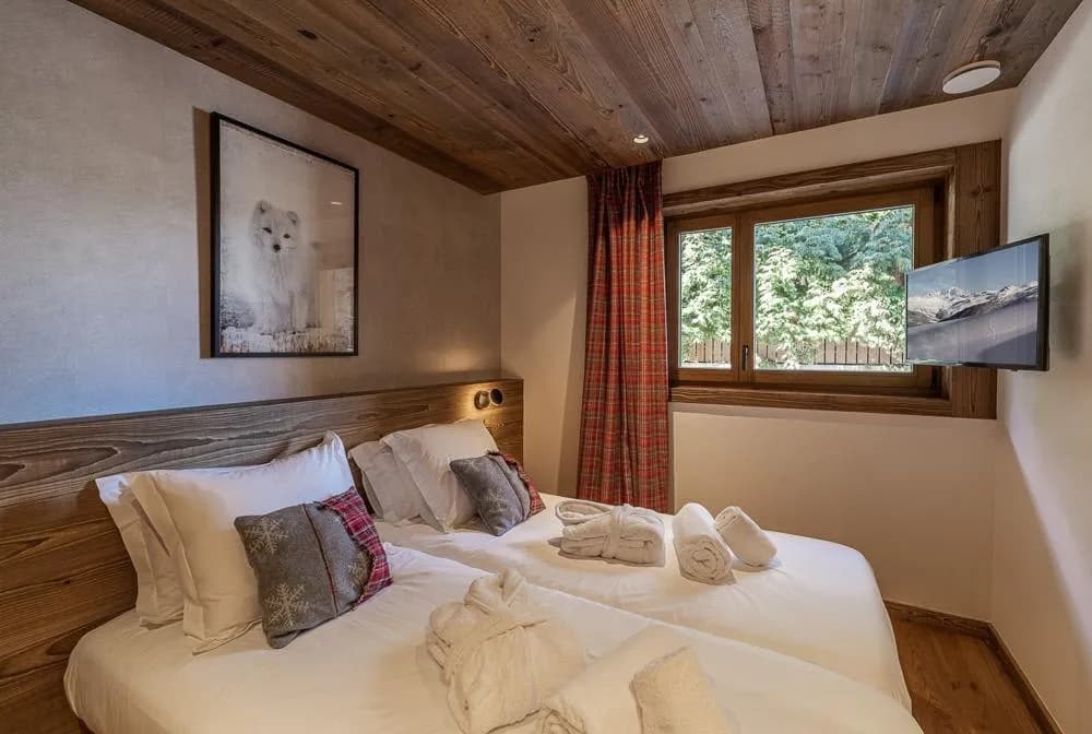 Bedroom with television and timber-clad ceiling