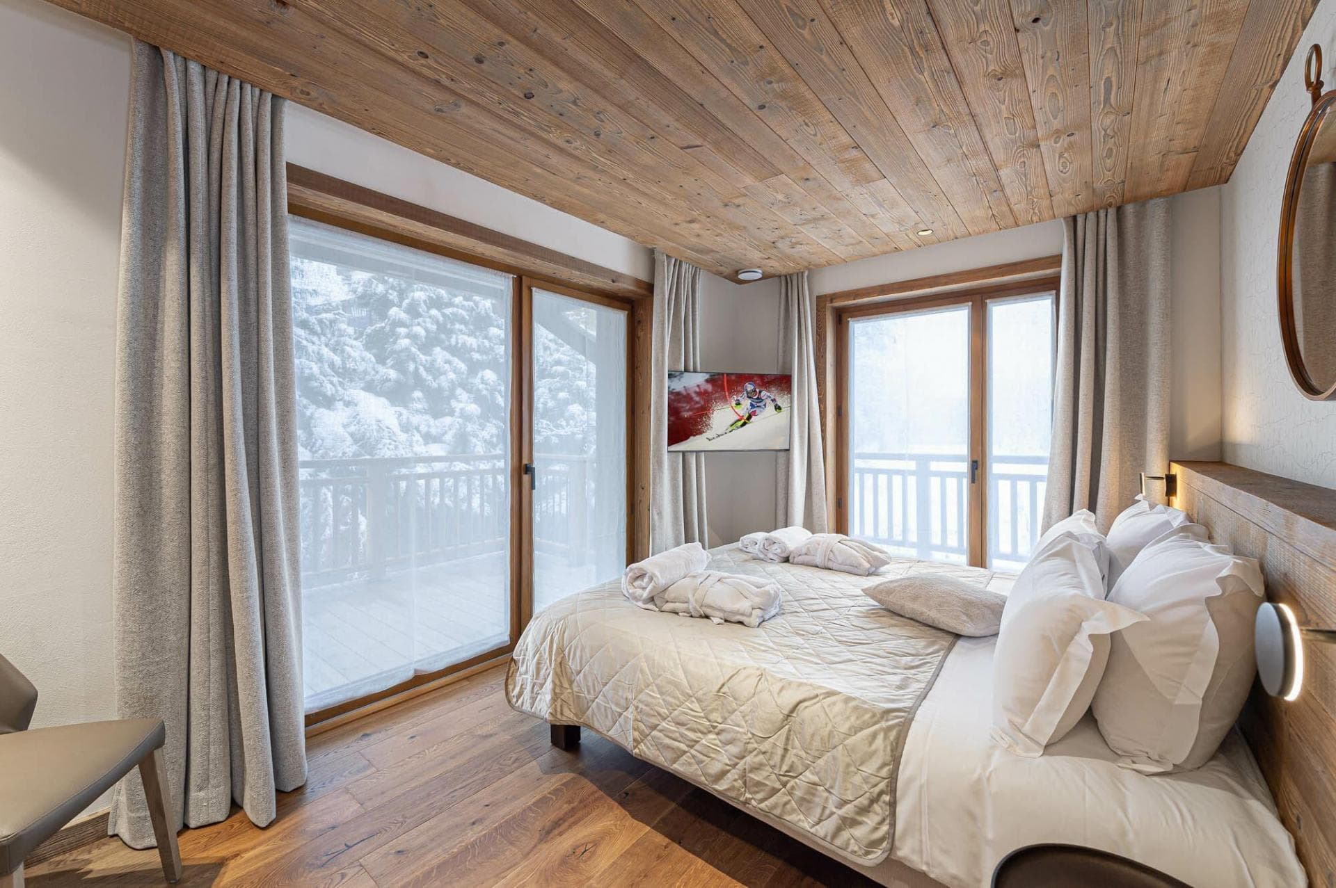 Bedroom with king bed and private balcony access to forest views