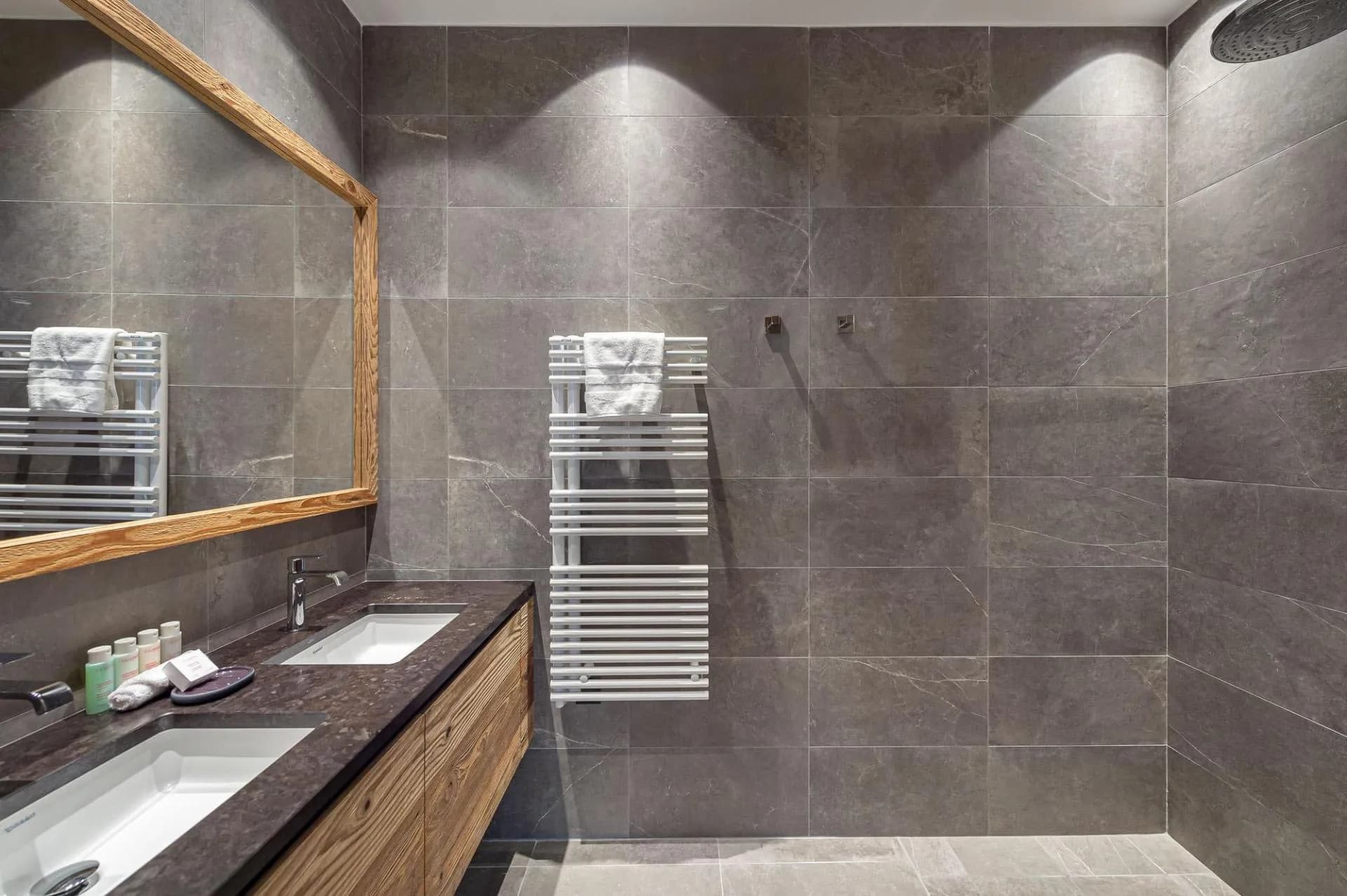 En-suite shower room with twin basins, heated towel rail and walk-in shower