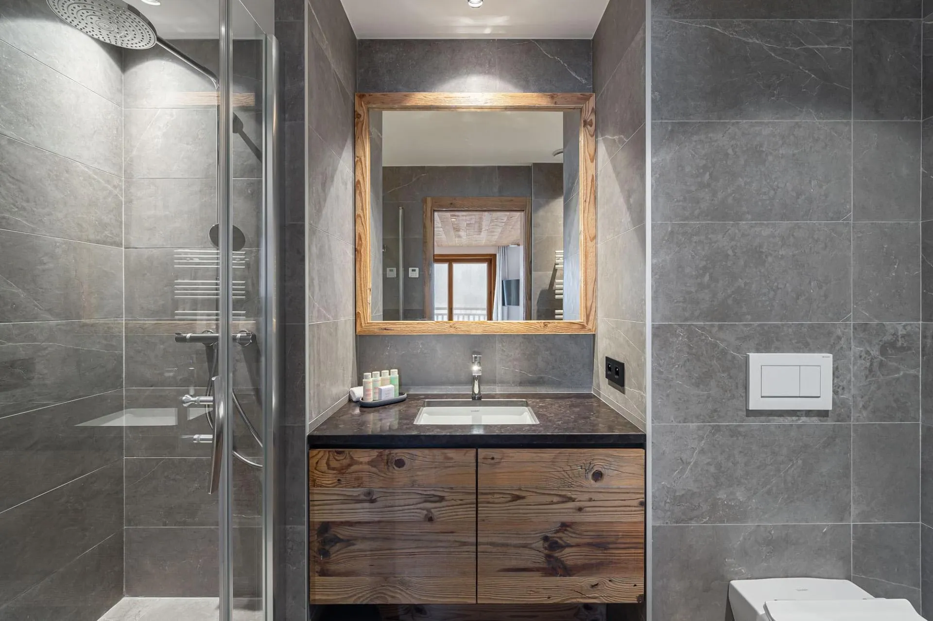 En-suite shower room with walk-in shower and heated towel rail