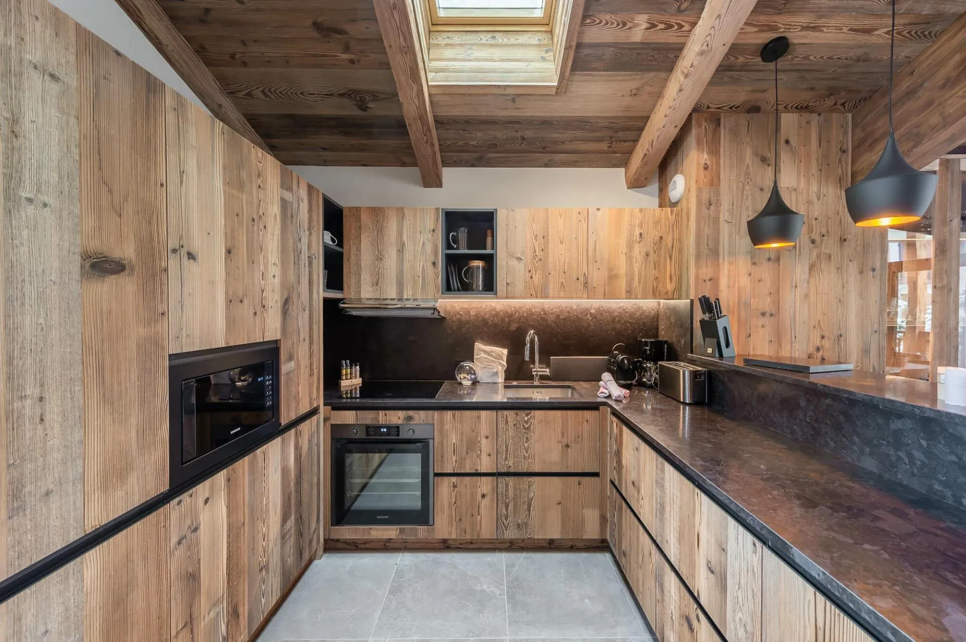 Kitchen with timber cabinetry, induction hob and overhead skylight