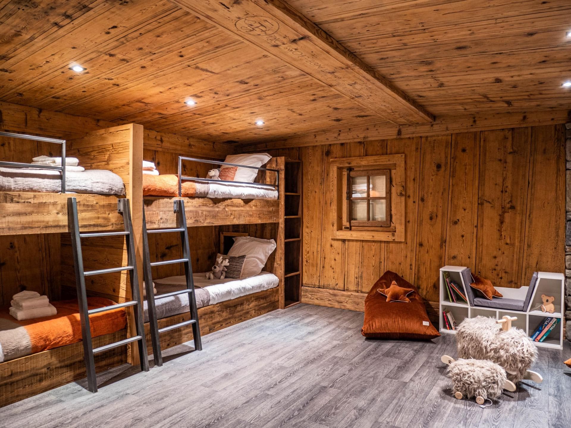 Bunk room sleeps 4; features integrated shelving and children's play area