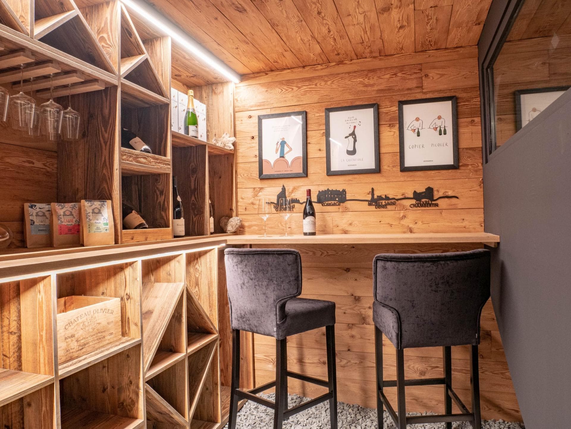 Wine cellar with tasting bar, velvet seating, and integrated bottle storage