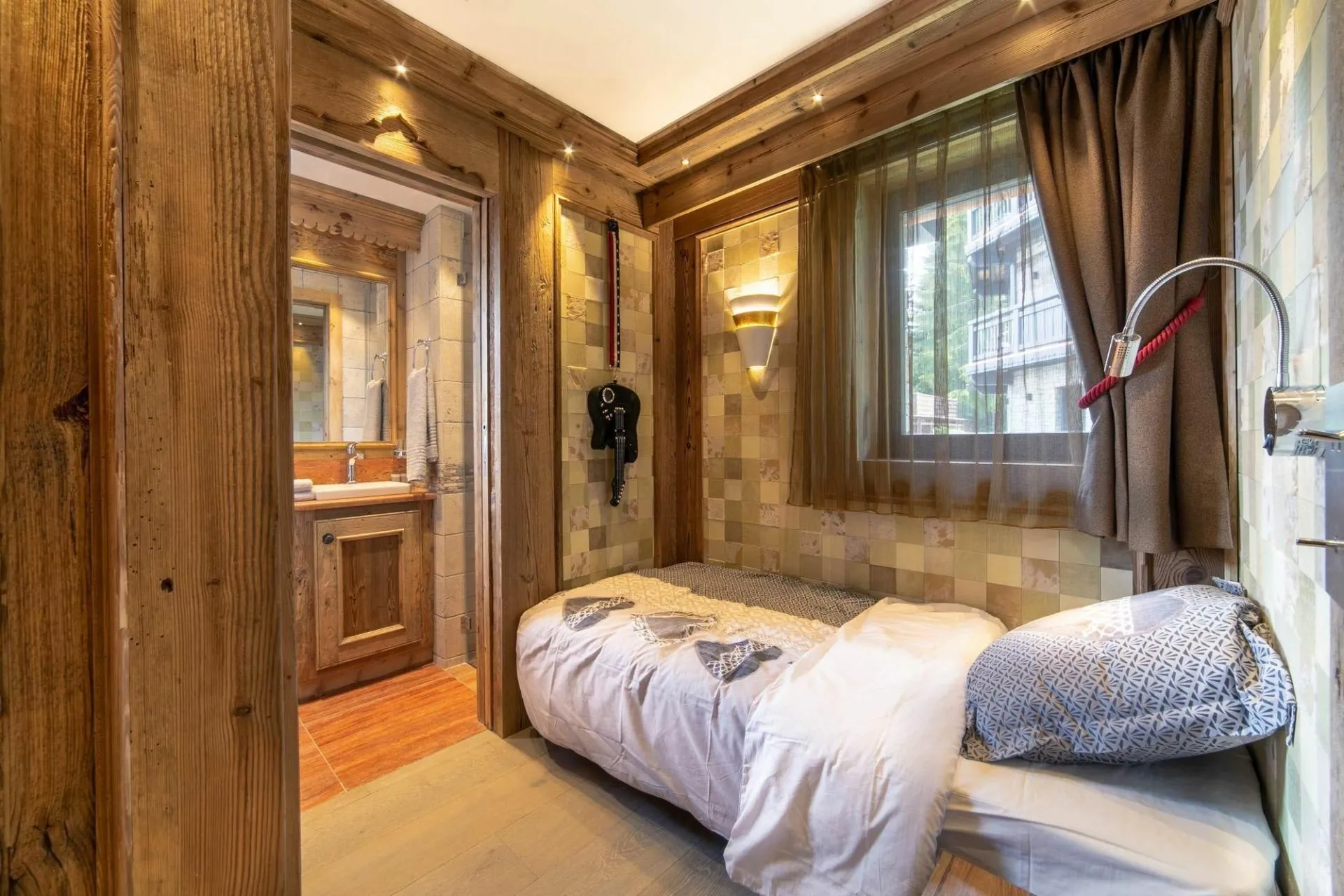 Single bedroom with timber walls and television