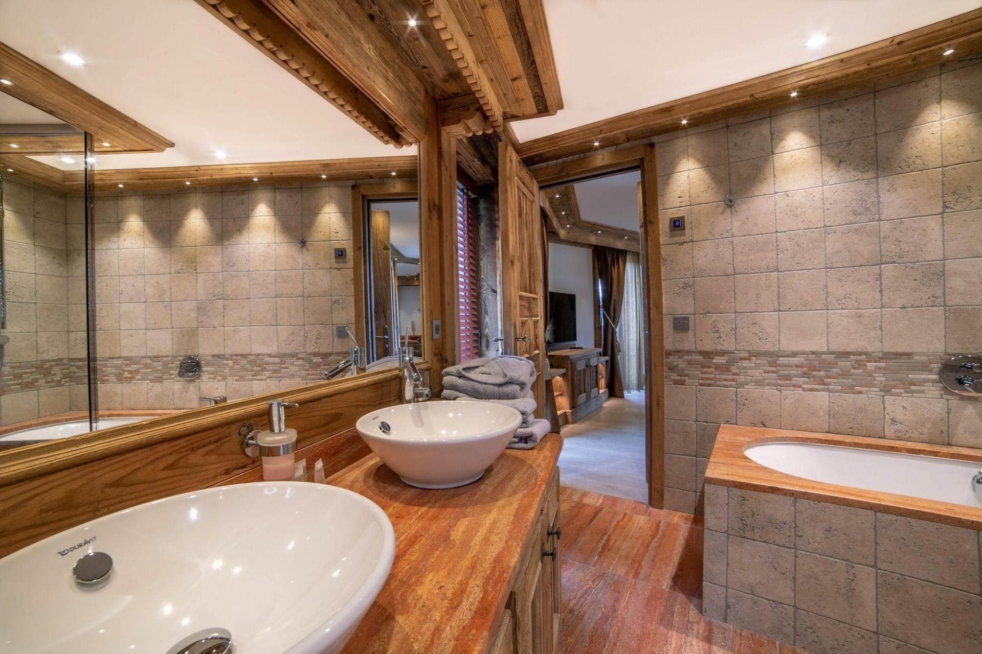 Primary bathroom with dual vessel sinks and soaking tub